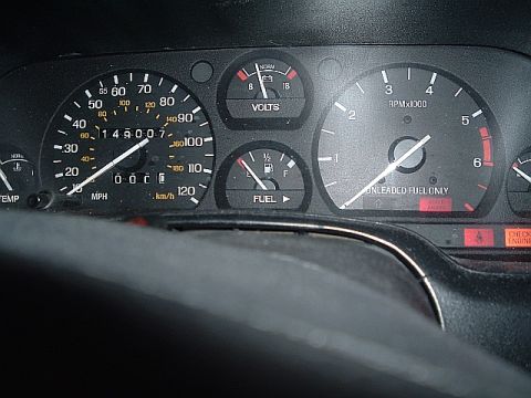 1994 Ford Thunderbird - Interior view of a car's dashboard gauges, including the speedometer, tachometer, fuel level, and voltage meter.