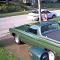 1970 Ford Ranchero - A green pickup truck with a white roof is parked in a driveway, with another vehicle visible in the background.