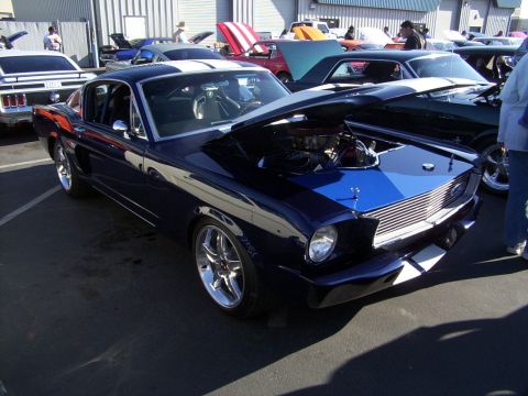 2002 Ford Mustang - Classic Ford Mustang with hood open at an outdoor car show.