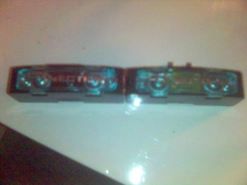 1994 Ford Probe - Close-up of a car's interior light assembly, showing its two bulb sockets and translucent covers.