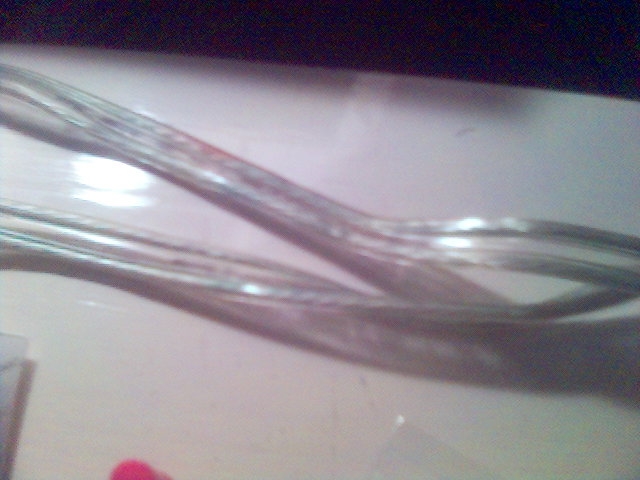 Clear wires with red and blue strands, on a light-colored surface. Text "SUPERMOTORS www.supermotors.net" is visible