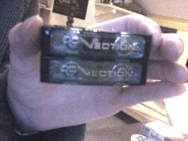 Two black electronic components with "VECTION" text held in a hand