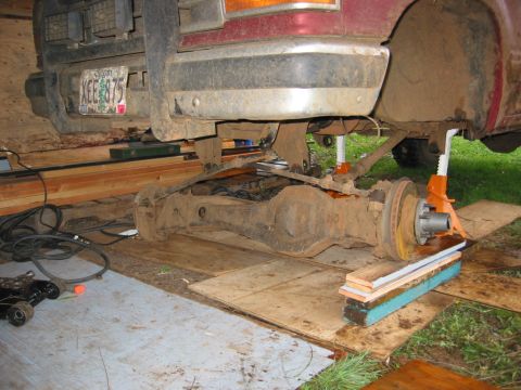 1991 Ford Explorer - Rear axle assembly being worked on, with a license plate visible on the vehicle above.