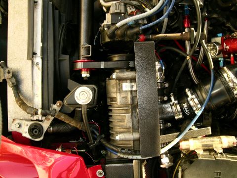 1993 Ford Probe - The engine bay features a prominent supercharger and various engine components.