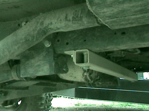 1977 Ford F-150 - Close-up of the undercarriage reveals aftermarket modifications to the truck's frame, including added square tubing.