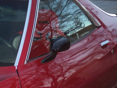 1972 Ford Ranchero - Side view of a 1972 Ford Ranchero, reflecting trees in the window.