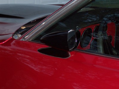 1972 Ford Ranchero - Close-up of a red car's side mirror and window trim.