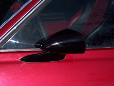 1972 Ford Ranchero - Close-up of a black side mirror on a red vehicle.