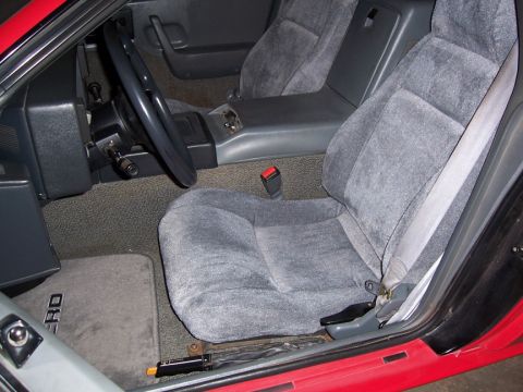1988 Pontiac Fiero - Interior view of a 1988 Pontiac Fiero, highlighting the driver and passenger seats and dashboard details.