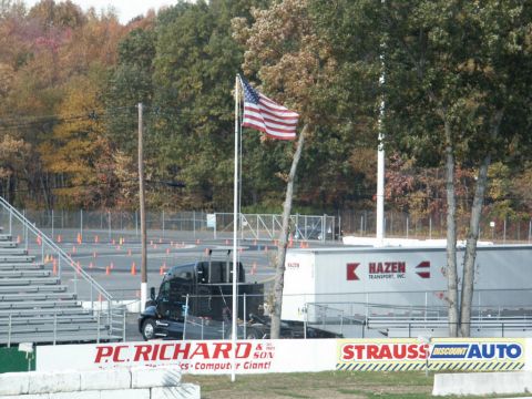 2001 Mercury Grand Marquis - A black truck and a white trailer are parked at an outdoor event with an American flag visible.