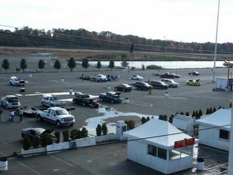 2001 Mercury Grand Marquis - A parking lot filled with numerous vehicles, including trucks and cars, under a cloudy sky.