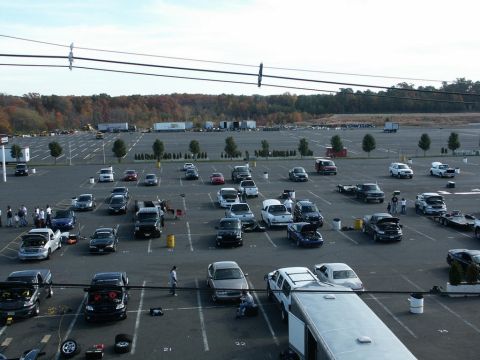 2001 Mercury Grand Marquis - A large parking lot filled with numerous vehicles, some undergoing maintenance or display.