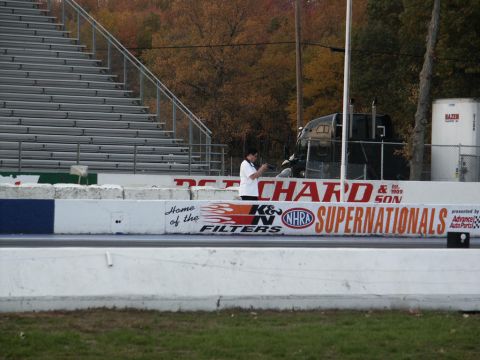 2001 Mercury Grand Marquis - A truck is parked at a drag strip with bleachers in the background.