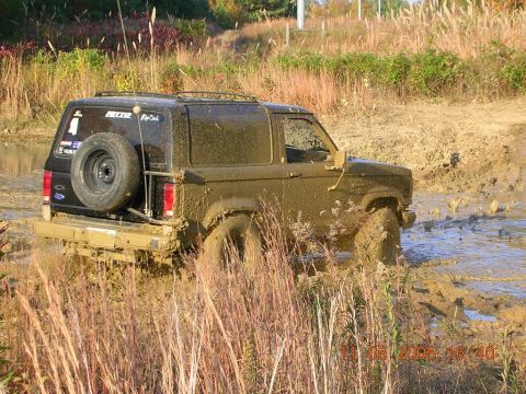 1989 Ford Bronco II - This 1989 Ford Bronco II navigates a muddy off-road course, its spare tire mounted on the rear.