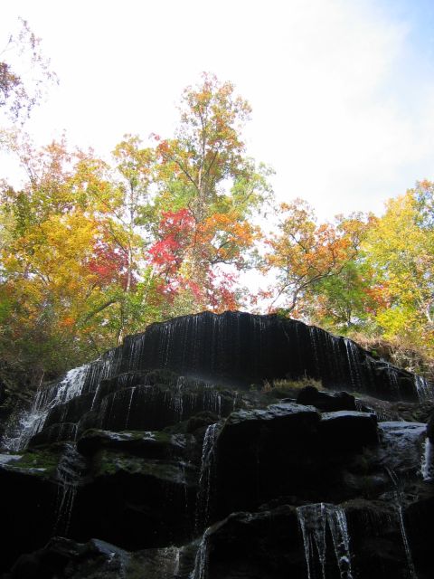 1985 Ford LTD Crown Victoria - A scenic view of a waterfall surrounded by trees displaying vibrant fall foliage.