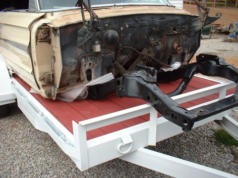 1964 Ford Galaxie - The front end of a 1964 Ford Galaxie is disassembled and loaded onto a trailer.