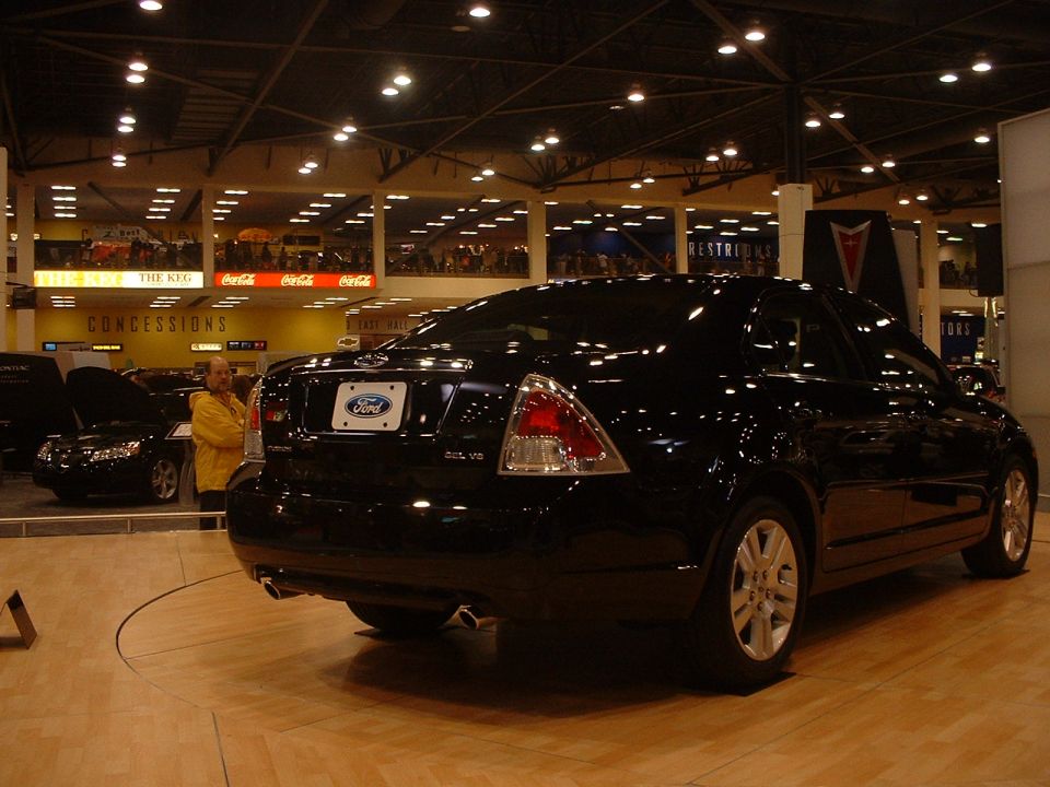 Black Ford sedan from rear, showing taillights and Ford badge