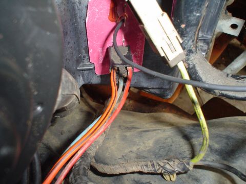 1984 Ford Bronco - A close-up view of a vehicle's electrical wiring harness, showing multiple colored wires connected to a central component.