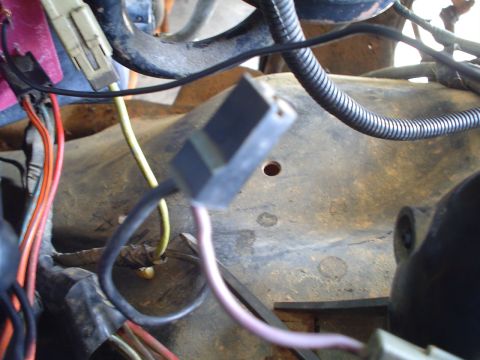 1984 Ford Bronco - A close-up view of a vehicle's wiring harness, showing various connectors and electrical cables.