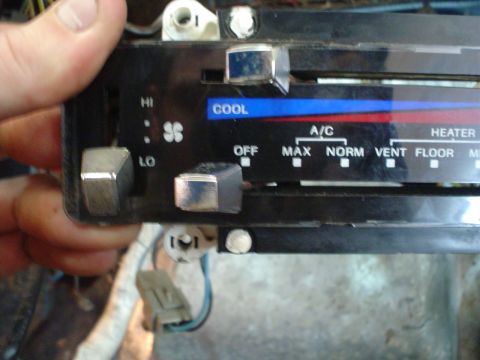 1984 Ford Bronco - Close-up of a vehicle's climate control panel showing fan speed and mode selection options.