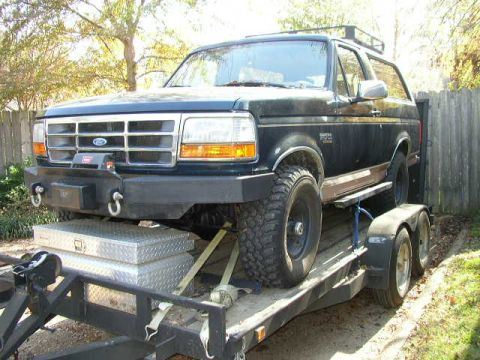 1995 Ford Bronco - This Ford Bronco is being transported on a trailer, equipped with a winch and heavy-duty bumper.