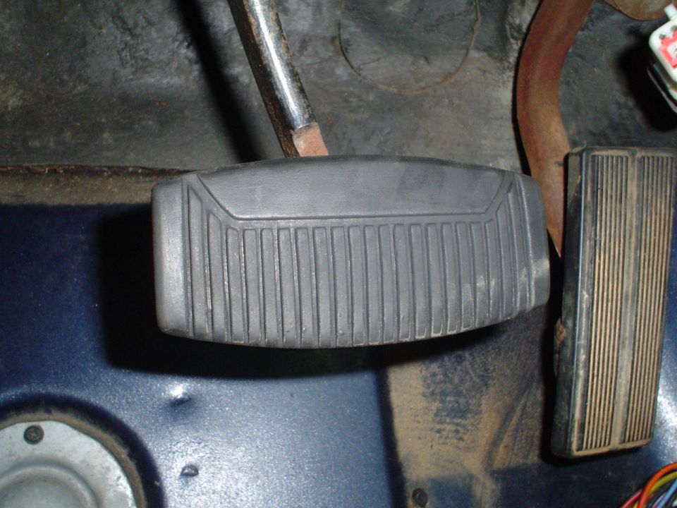 close-up of brake and gas pedals inside a vehicle