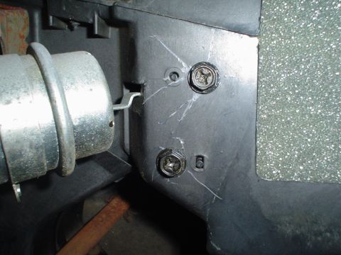 1984 Ford Bronco - This photo shows a close-up of a vehicle's interior panel, focusing on two screws and a metal part.
