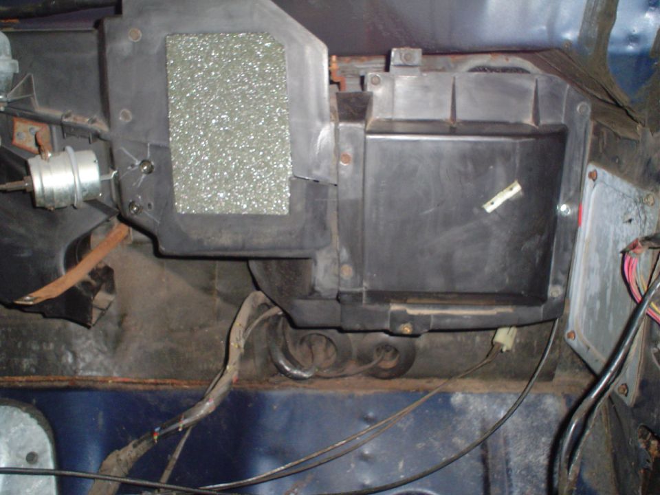HVAC heater core box and ducting with wiring and insulation visible