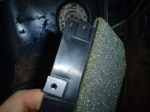 1984 Ford Bronco - A close-up view of a car's interior component, possibly a bracket or housing, with foam insulation.