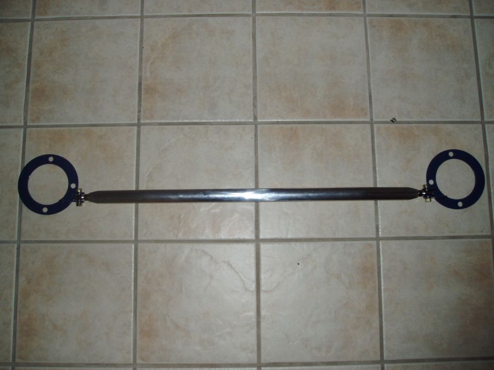 Aftermarket strut tower brace with blue mounting plates