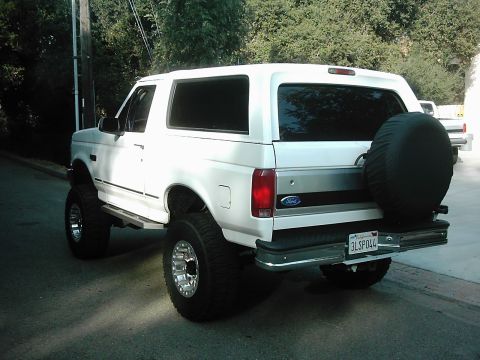 1978 Ford Bronco - This white Ford Bronco features a lifted suspension and a spare tire mounted on the rear tailgate.