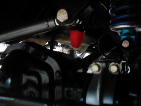 1978 Ford Bronco - Close-up of the undercarriage shows suspension components and a differential housing.
