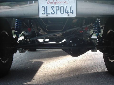 1978 Ford Bronco - The underside of a vehicle, focusing on the rear axle, suspension, and exhaust system.