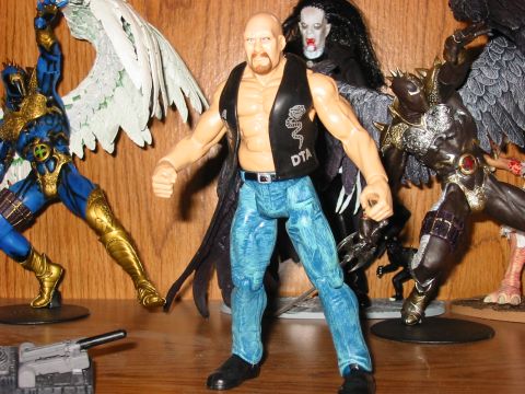 1991 Ford Bronco - A collection of action figures, including wrestling and fantasy characters, are displayed on a wooden shelf.