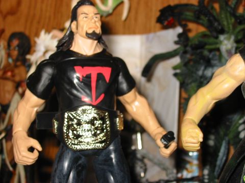 1991 Ford Bronco - Action figure with a championship belt and a 'T' logo on its shirt.