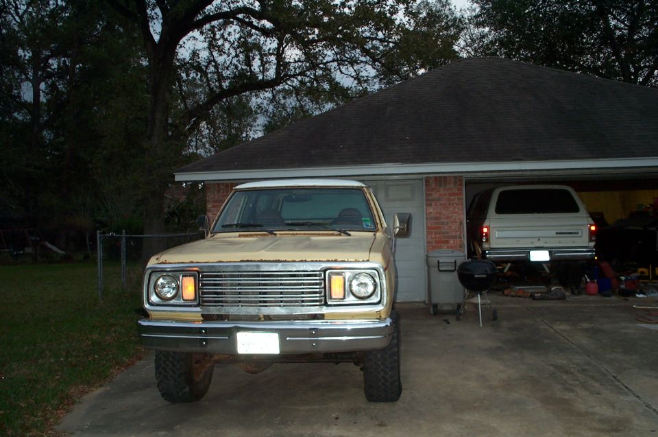 1978 Dodge Power Ram pickup truck front end, parked in driveway. Another vehicle is in the garage behind it