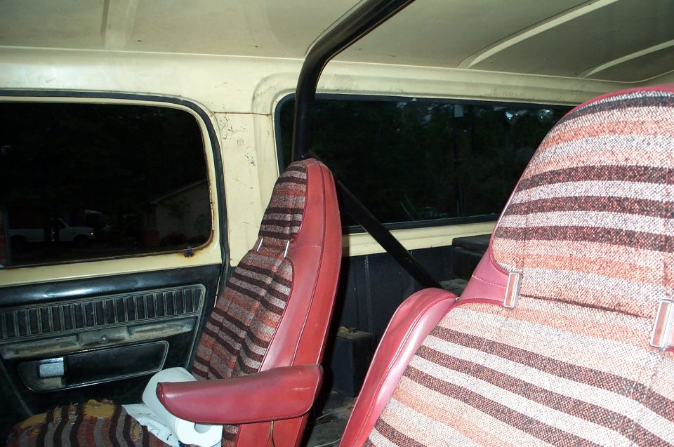 Interior view of striped seats and roll bar in a vehicle