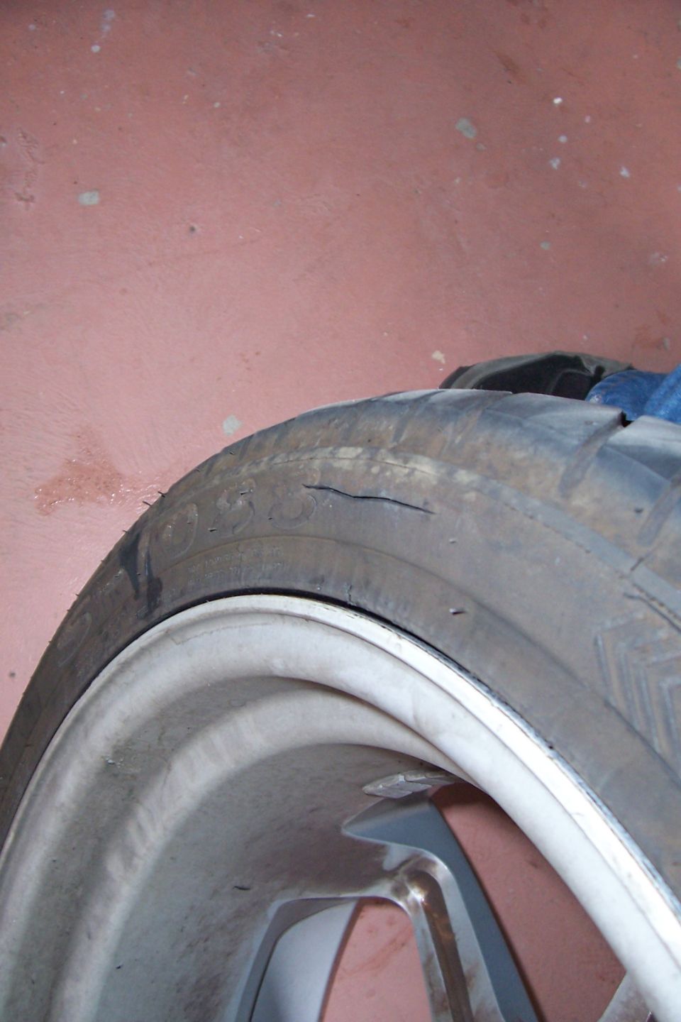 close-up of a worn tire with a crack on the sidewall