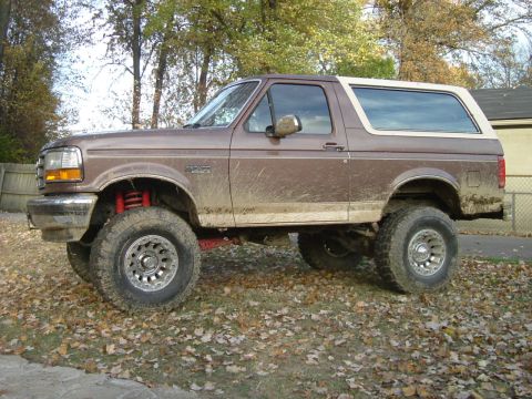 1993 Ford Bronco - This lifted 1993 Ford Bronco is shown in a side profile, covered in mud.