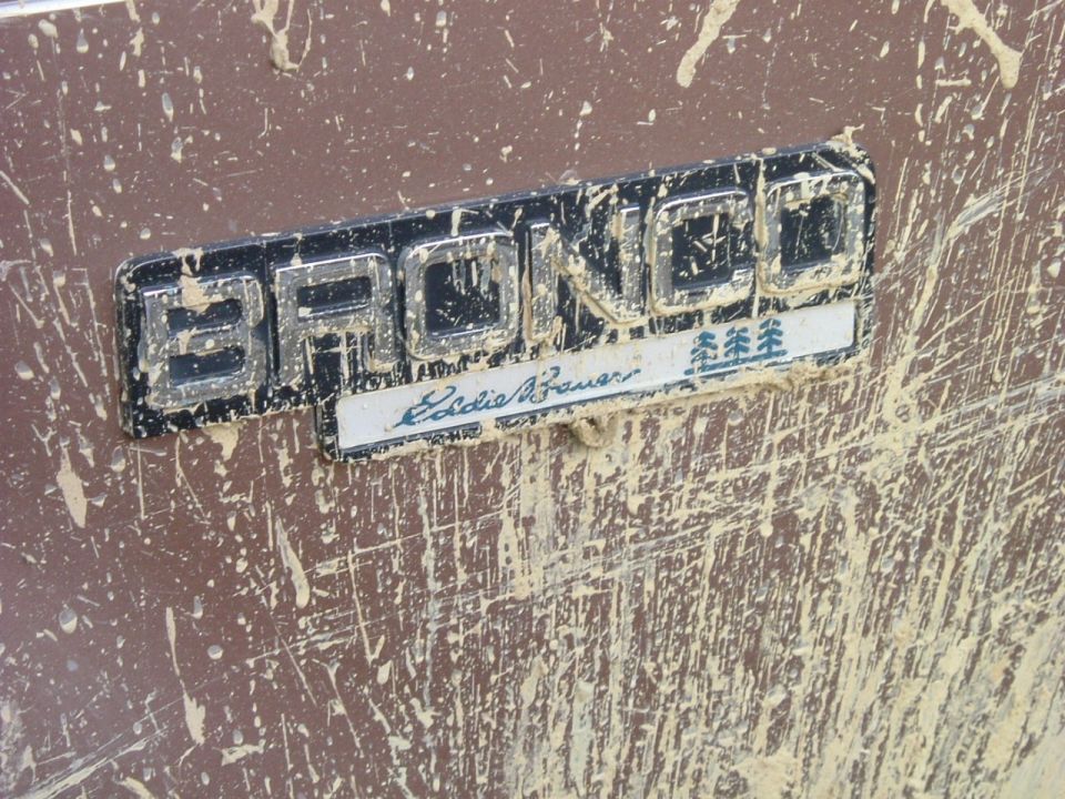 Muddy Bronco Eddie Bauer fender badge on maroon-brown paint