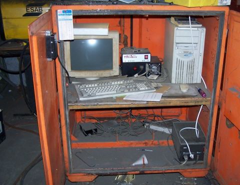 1979 Ford Bronco - An orange cabinet houses a vintage computer setup, complete with a CRT monitor and keyboard.