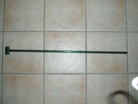 1993 Ford Taurus - A dark green metal bar with a T-shaped bracket is shown against a tiled surface.