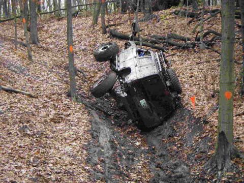 1992 Ford Bronco - This vehicle is stuck in a muddy off-road course, marked with orange flags.