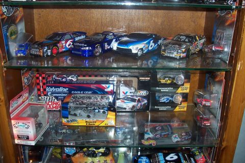 1987 Ford Bronco - A display case filled with various NASCAR diecast models, multiple brands and race car liveries.