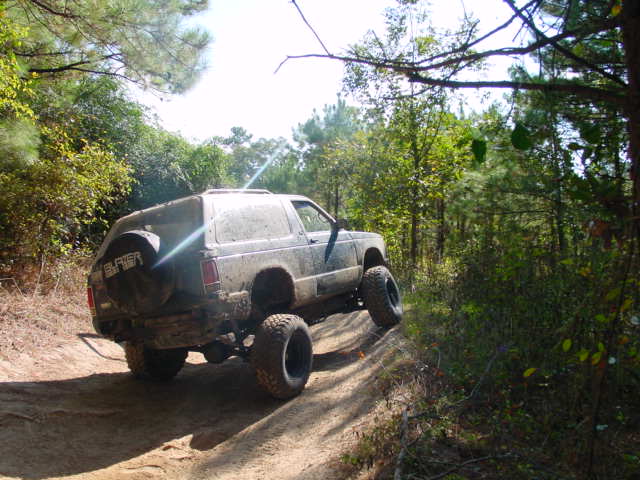 1992 Chevrolet S10 Blazer off-roading on a dirt trail, rear view