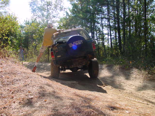 1992 Chevrolet S10 Blazer on dirt trail, man hanging off rear door
