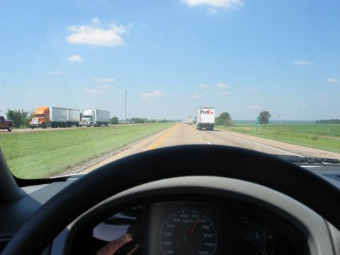 2004 Ford F-150 - View from inside a vehicle on a highway, showing the dashboard and other trucks on the road.