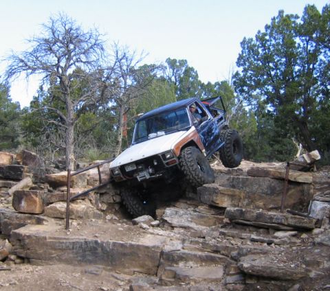 1981 Ford Bronco - This 1981 Ford Bronco is tackling a challenging rocky obstacle on an off-road course.