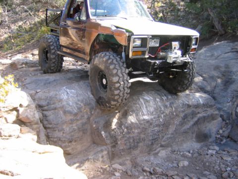 1981 Ford Bronco - This modified 1980s Ford Bronco navigates a challenging rocky terrain.