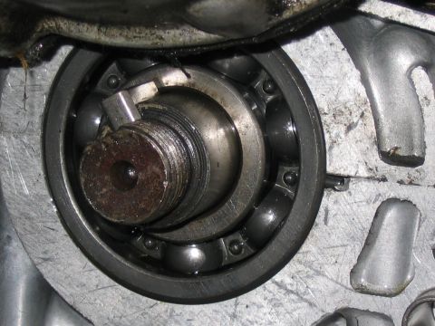 1997 Yamaha YT60 Tri-Moto - Engine bearing and shaft assembly with visible ball bearings and retaining clip.